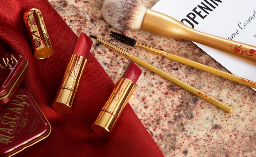 Bésame Cosmetics Red Lipstick next to Makeup Brushes
