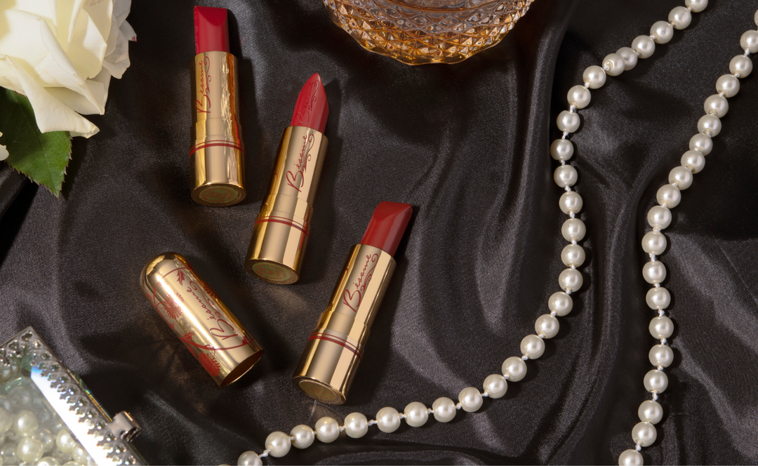 Bésame Cosmetics red Lipstick next to Pearls